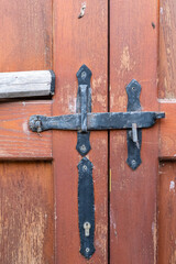 Antique iron locking system on a wooden door