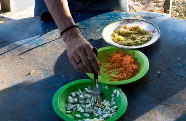 Hand of unidentifiable person serving food
