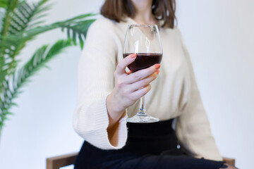 woman in white dress drinking wine from a wine glass