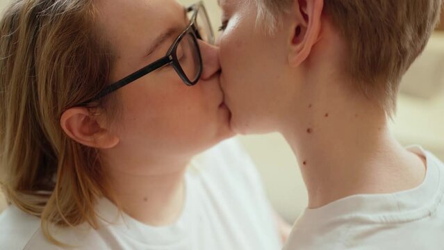 two women in love, one with glasses, a gentle kiss. love. intimacy, lgbt couple.