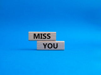 Miss you. Concept word Miss you on wooden cubes. Beautiful blue background. Business and Miss you concept. Copy space.