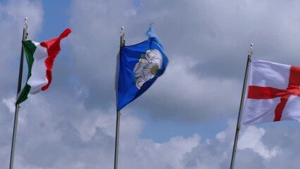 Flags of Yorkshire, Ireland and England blow on windy day