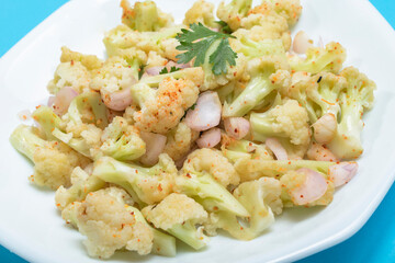 Healthy food cauliflower salad in plate dish on blue background.
