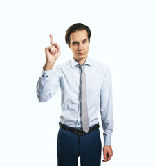 Warning concept wih young handsome man in white shirt with raising hand and forefinger isolated on light wall background, closeup