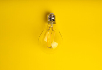 Electric light bulbs. the concept of energy efficiency. Composition on a yellow background. Use an economical and environmentally friendly light bulb concept.