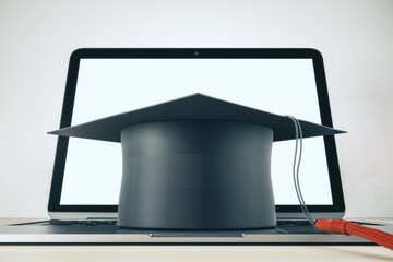 Online education and college university study with black mortarboard hat on laptop keyboard. 3D rendering - Powered by Adobe