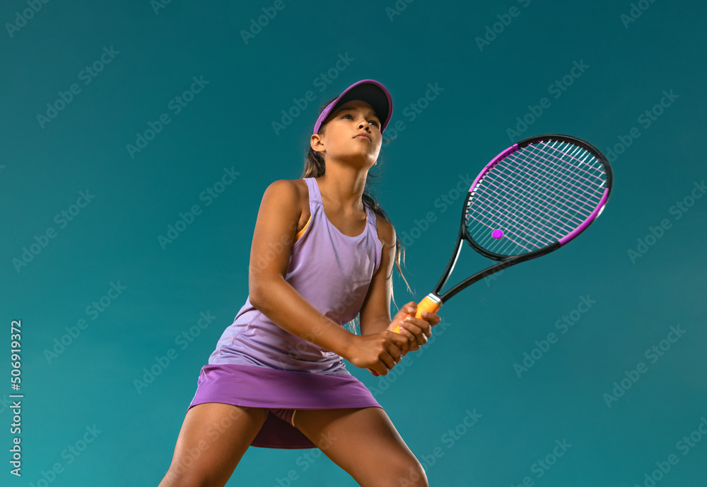 Wall mural tennis player. beautiful girl teenager and athlete with racket in pink sporswear and hat on tennis c