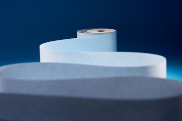 blank adding machine tape against blue background