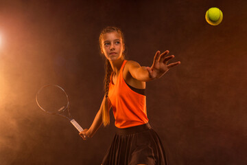 Tennis player. Beautiful girl teenager and athlete with racket in sporswear and hat on tennis...