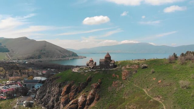 Sevanavank Monastery on Lake Sevan, Armenia. Flying around the Temple at sunny day. The temple on the mountain. High quality 4k footage