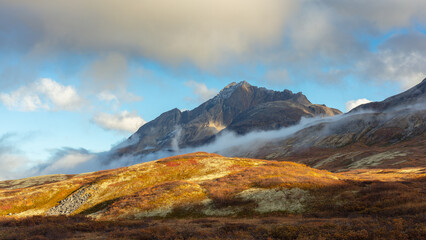 Mountain landscape in autumn colors with mist and low clouds, Kluane National Park, Canada