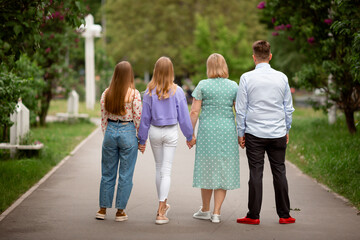 Vinnytsia, Ukraine. May 16, 2022. A large family walks together in a park with lots of bright lilacs