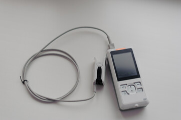 Pulse oximeter on a white background. Medical control and diagnostic device for measuring the saturation of capillary blood with oxygen