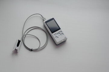 Pulse oximeter on a white background. Medical control and diagnostic device for measuring the saturation of capillary blood with oxygen