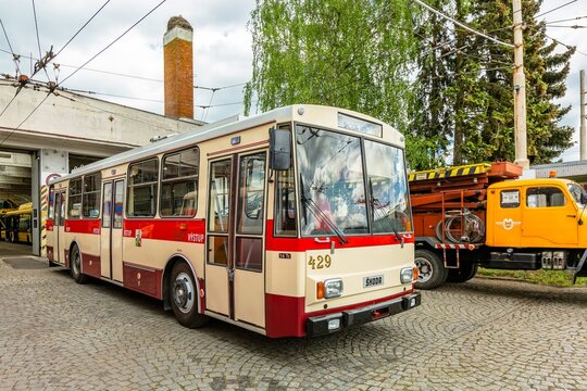 Marienbad, Czech Republic - May 21 2022: An old Skoda trolleybus,  14Tr, standing in front of a garage on grey cobblestone paving. Anniversary of 120 years of public transportation in the city.