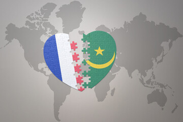 puzzle heart with the national flag of france and mauritania on a world map background. Concept.