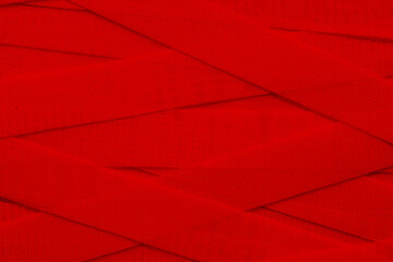 Background of intertwined medical dressings in red. Template with red cloth