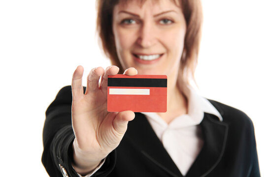 Cheerful businesswoman showing credit card isolated over white background