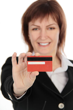 Cheerful businesswoman showing credit card isolated over white background
