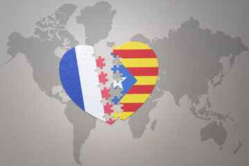 puzzle heart with the national flag of france and catalonia on a world map background. Concept.