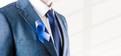 Men cancer prostate. Hipster man with blue ribbon in hands on white background. Awareness prostate of health in November. Adrenocortical carcinoma concept.