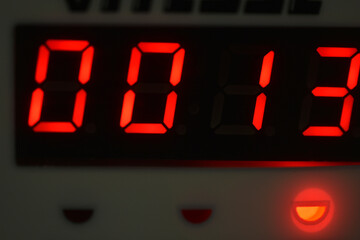 The number 13 on the electronic clock display