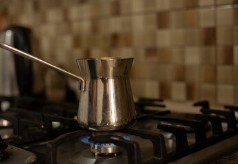 Fototapeta na wymiar coffee stands on a gas stove closeup