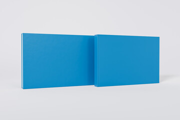 Mockup of a rectangular book with a blank glossy blue cover on white background. Front and back cover visible. Isolated with clipping path.	