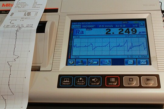 Display and control panel of surface roughness modern digital measurement system Mitutoyo SurfTest, with results of measurement visible on display and in printed form from built-in printer. 