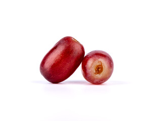 Closeup of two ripe grapes on a white background.