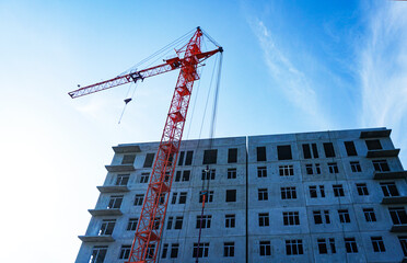 Fototapeta premium A crane that builds multi-story homes
