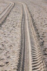 a tire track in the sand on the beach