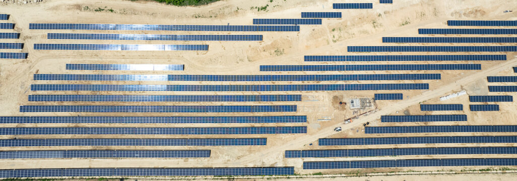 aerial view of solar panels under construction. power farm producing clean energy