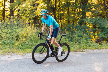 Fototapeta na wymiar Male professional road cyclist during a race in blue dress