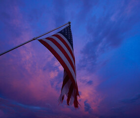 American flag waving over the sunset on the 4th of July