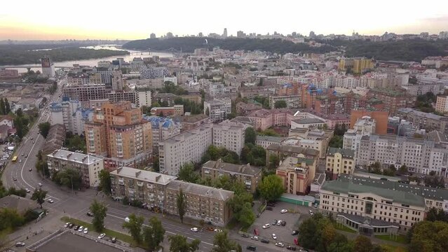 an aerial view of a beautiful sunset, overlooking the river dnipro and the podol district, kiev, ukraine