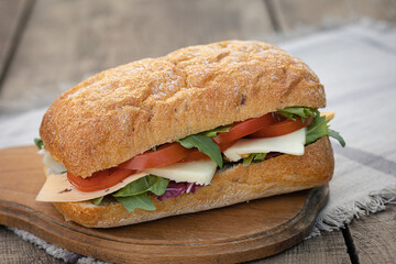 Homemade ciabatta sandwich on a wooden table