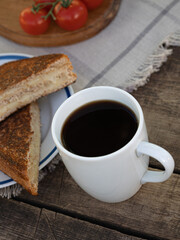 Black coffee with French toast on a wooden table