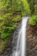 Fototapeta na wymiar vertical view to forest waterfall in Ukrainian Carpathy