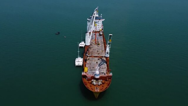 Transport ship workers load the monohull boat on board for shipment to Europe. Monohull Dream Yacht Charter before shipping to owner