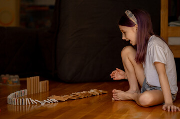 a girl is playing with wooden sticks