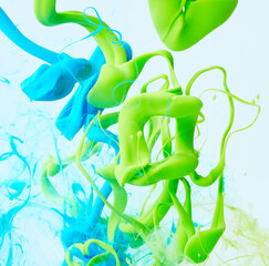 Paints splash curves in water on white. Acrylic paint drop background. Abstract green and blue colors swirl texture