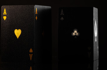 Black poker cards. Isolated on black background. Gambling, poker, casino, excitement, online casino. Gambling business, hobby, risk, win. There are no people in the photo.