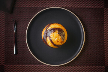 Vanilla Muffin with chocolate marbled in brown paper