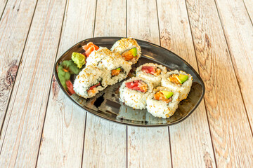 California roll uramaki sushi with red tuna, avocado, Norwegian salmon, wasabi, nori seaweed and Japanese rice