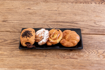 Assorted pastry tray with butter croissants, snails and chocolate Neapolitan