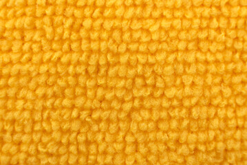 Texture of a carpet or towel in yellow color close-up. Material. Textile