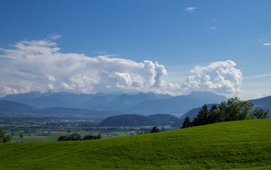 Sunny mountain landscape with blue sky and white clouds