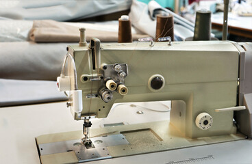 Industrial sewing machine. Textile factory sewing workshop.