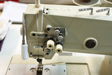 Industrial sewing machine. Textile factory sewing workshop.